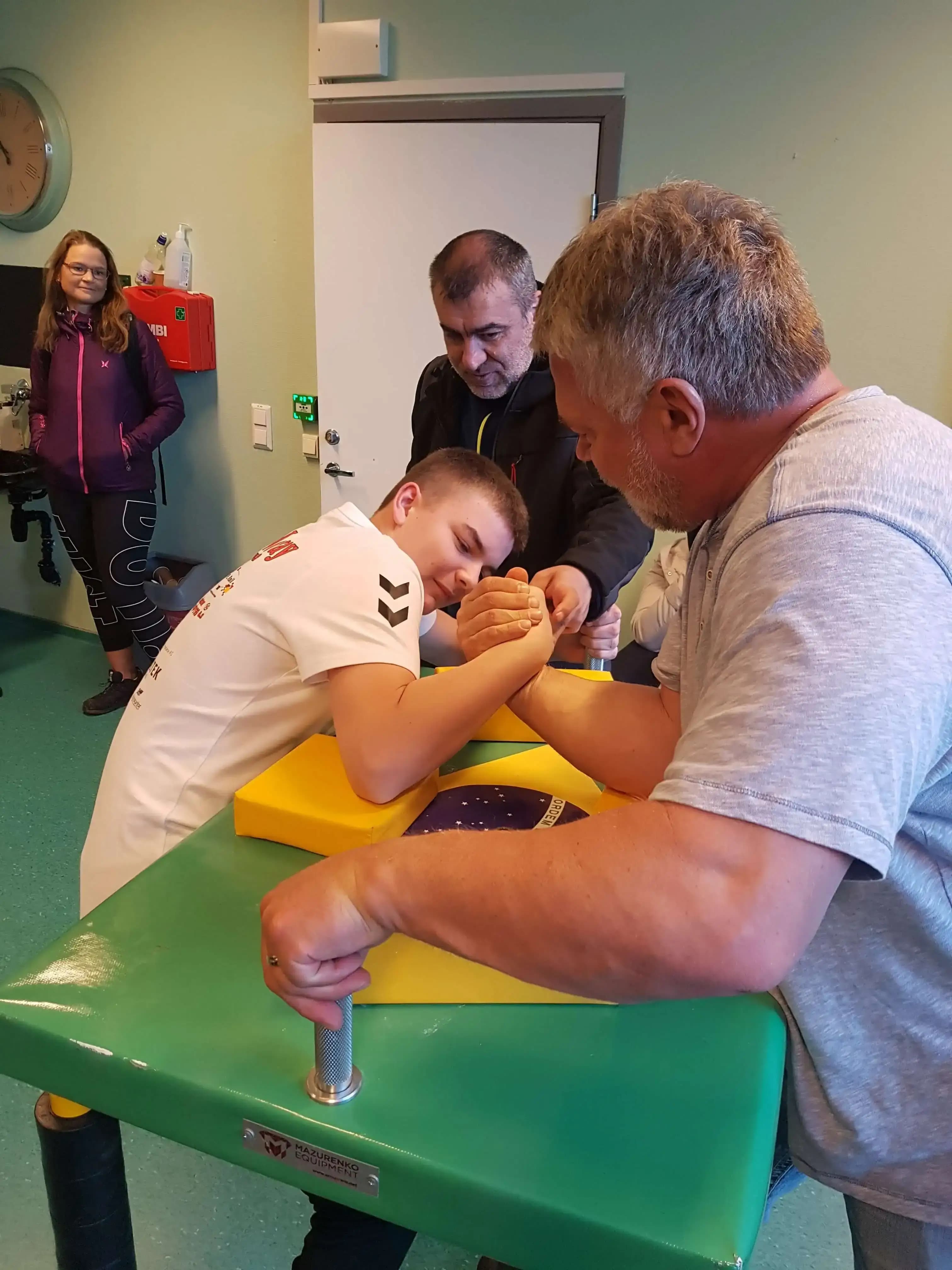 Young and old armwrestling